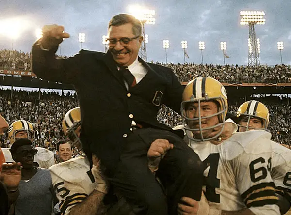 Legendary coaching lineage:  Vince Lombardi being carried off the field by Jerry Kramer